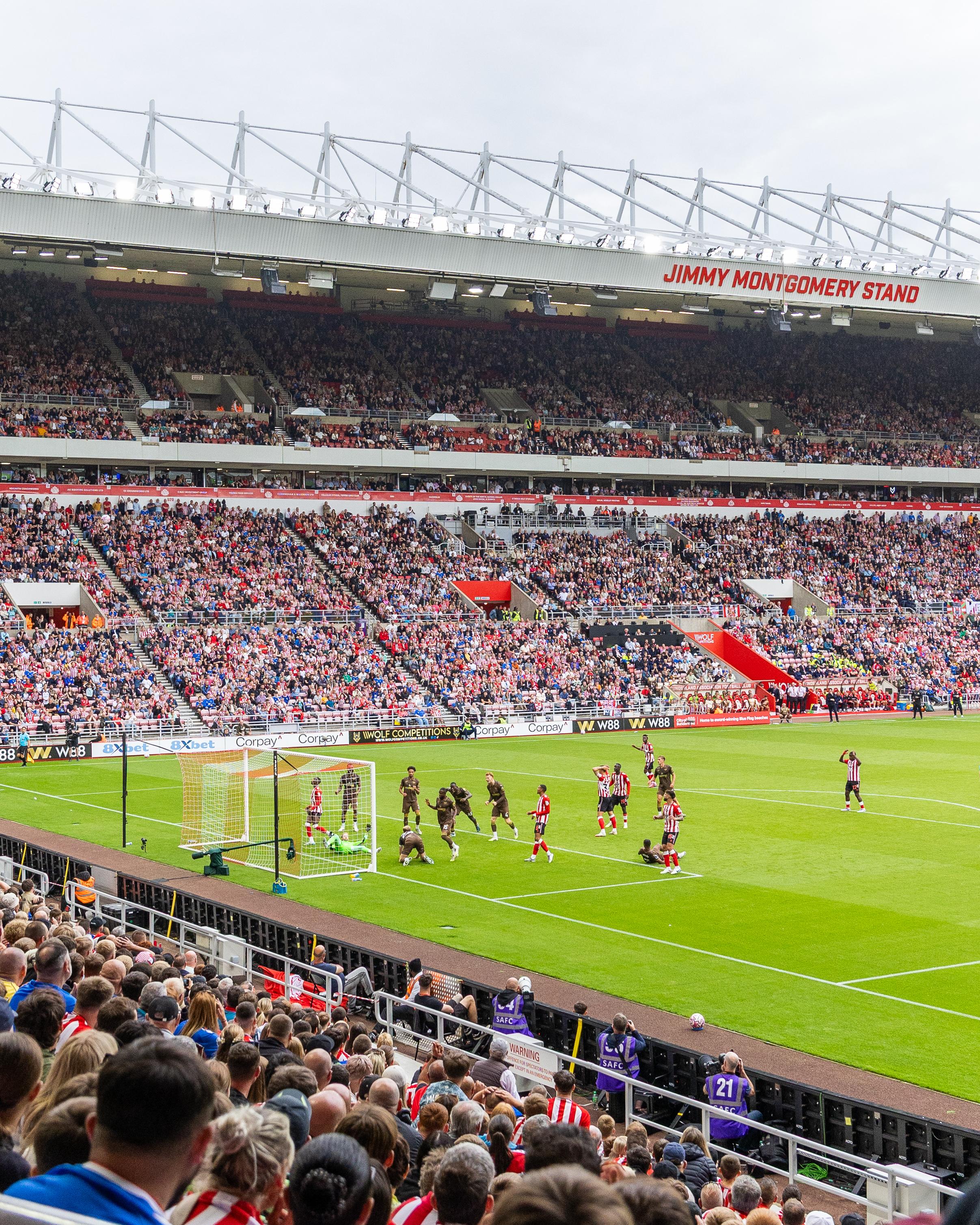 Players and fans during a football match